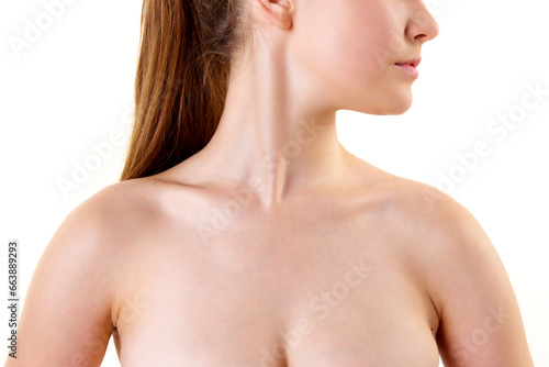 Cropped photo of young female body. Bare shoulders, neck, collarbones, bust of woman. Skincare cosmetic treatment affect.