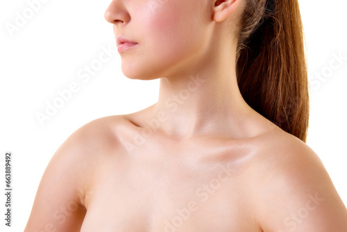 Close up cropped photo of young female body. Bare shoulders, neck, collarbones, bust of woman. Skincare cosmetic treatment affect.