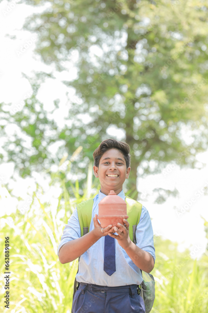 holding traditional piggy bank or Gullak holding traditional piggy bank or Gullak