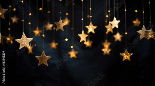 Hanging gold stars on a dark background