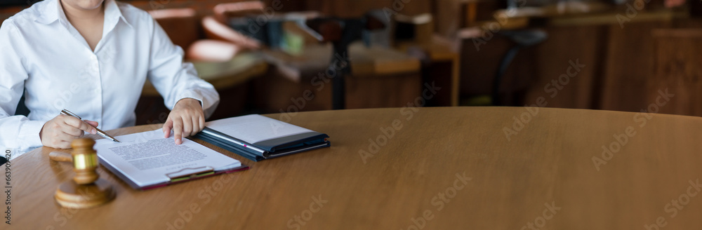 Hands of lawyer woman pointing on paper to reading legal agreement and signing on business contract Hands of lawyer woman pointing on paper to reading legal agreement and signing on business contract