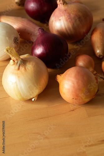 different kinds of onions on a wood table