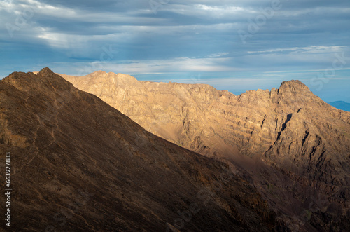 Panorama from trail to Toubkal  ridges and highest peaks of High Atlas mountain in Morocco on sunrise