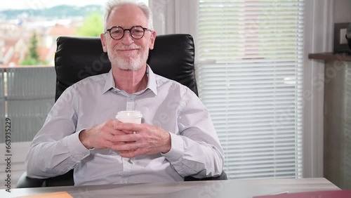 Smiling businessman having coffee break at office