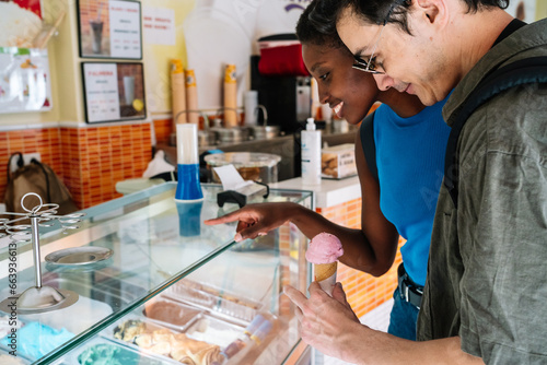 Wallpaper Mural Multi-ethnic couple choosing a ice cream in a shop Torontodigital.ca