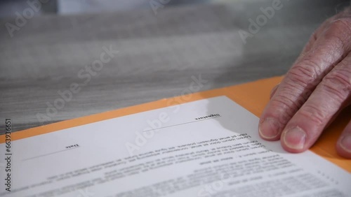 Hand signing a document, close up