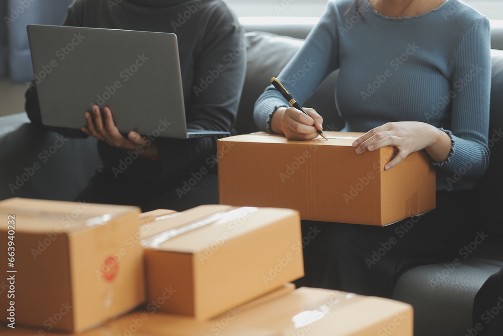 Business woman start up small business entrepreneur SME success .freelance woman working at home with Online Parcel delivery. SME and packaging deliveryconcept Business woman start up small business entrepreneur SME success .freelance woman working at home with Online Parcel delivery. SME and packaging deliveryconcept