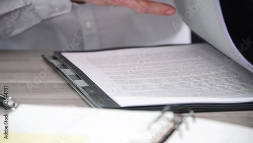 Hand of businessman opening a folder