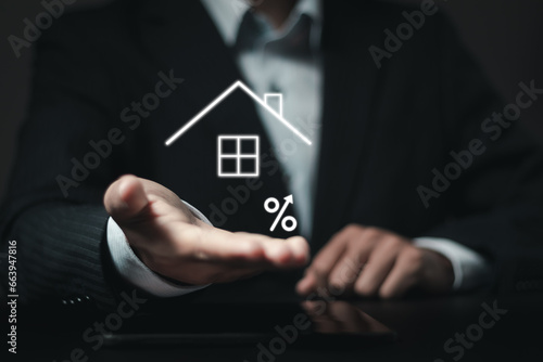 Businessman showing house symbol with percent up for property interest rate and finance loan increase and business real estate concept.