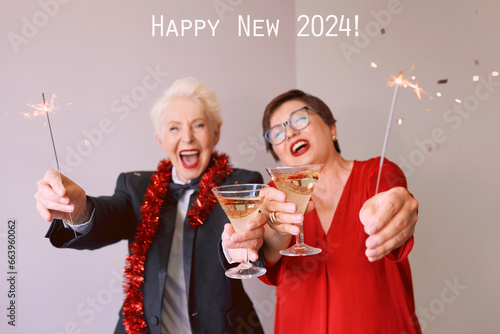Two beautiful stylish mature senior women celebrating new year. Fun, party, style, celebration concept