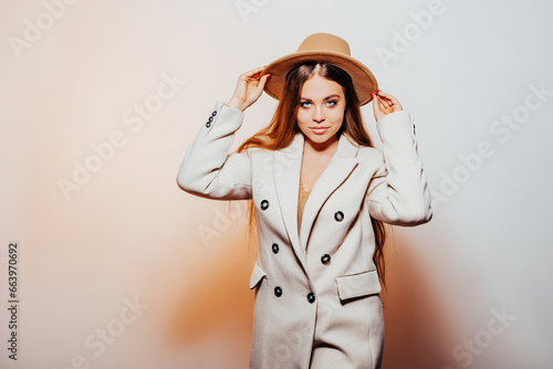 happy girl in stylish and hat posing in studio