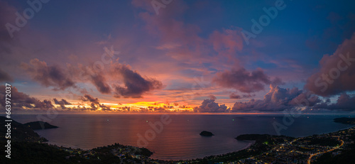 Fototapeta Naklejka Na Ścianę i Meble -  .aerial view lighting in twilight at Kata beaches and Karon beach..stunning cloud moving in colorful sky at twilight above the islands..panorama beautiful yellow reflection on sea surfect background.