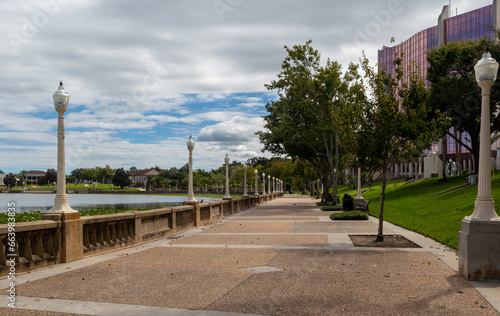 Trees and light posts along walking promenade of Lake Mirror in Lakeland, Florida