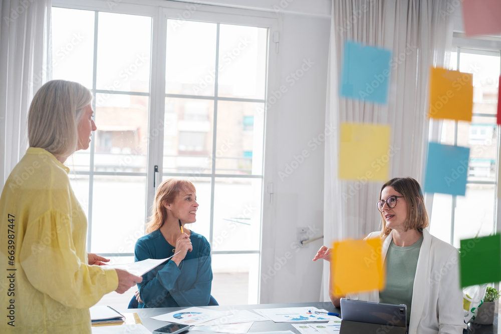 © Ivan - Three successful business women carrying out investment and growth tasks for their company. Concept: business, investment, leadership