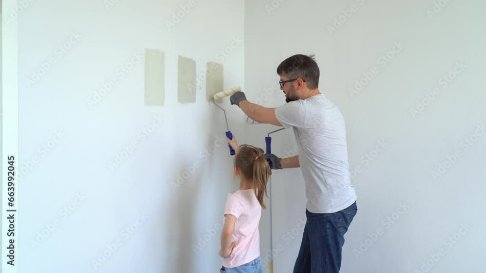 Happy family, father and little daughter choose wall paint on test of ...
