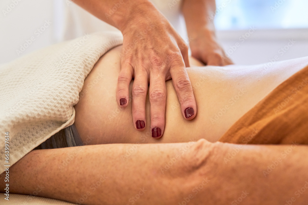 Osteopath massaging woman back on an ayurveda treatment to relax muscles and nerves - obrazy, fototapety, plakaty 