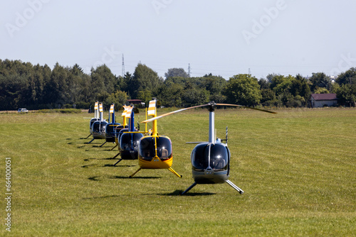 Helicopters, Robinson (R44) on grass airfield photo