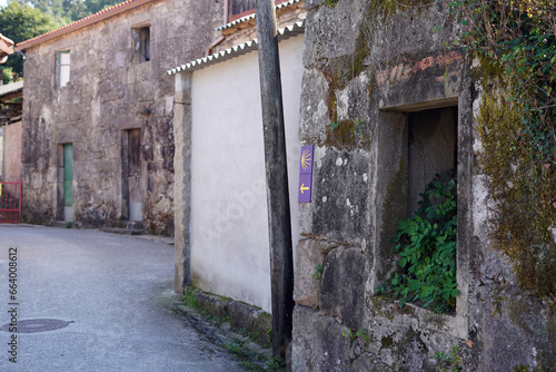 Old city street. The buildings are old and we see a signpost.