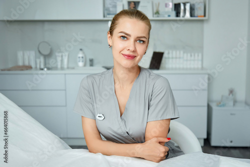 Portrait of friendly female woman beautician, aesthetic nurse or masseuse at her workplace. photo