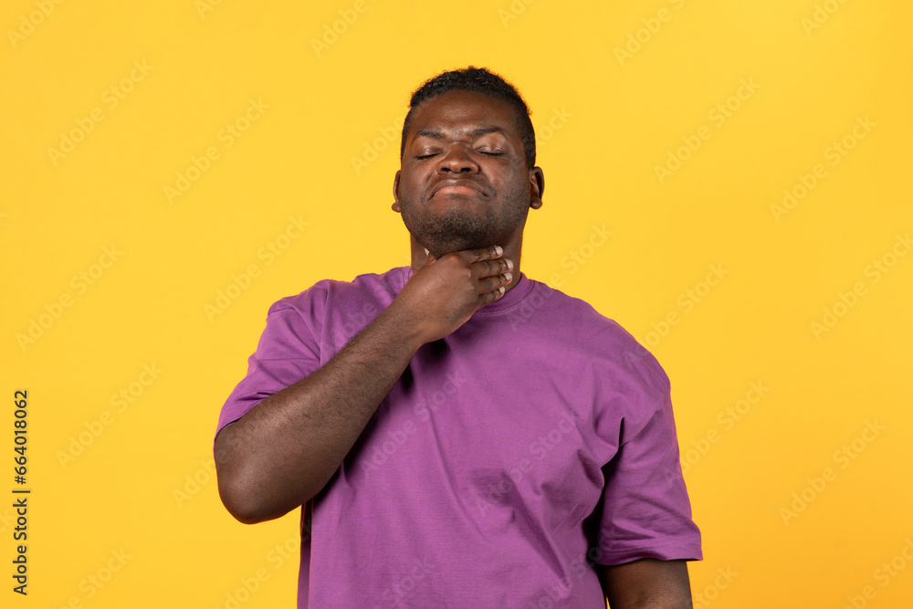 Black man touching inflamed neck suffering from sore throat pain Black man touching inflamed neck suffering from sore throat pain