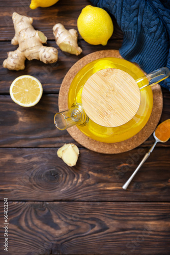 Healthy turmeric hot drink tea with lemon, ginger and honey on rustic table. Alternative medicine concept, immune system booster in winter. View from above. Copy space.