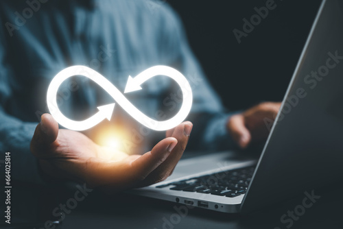 Businessman presents circular infinity symbol, signifying circular economy and infinite potential. Strategy of sustainable investment, banking, and financial growth. technology infinity data