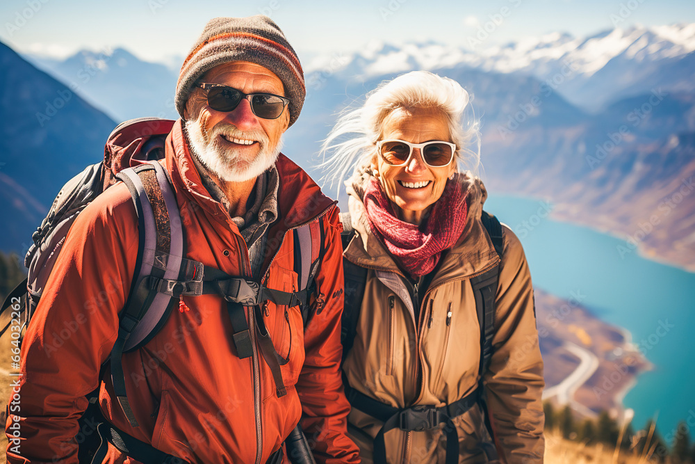Portrait of a happy retired couple traveling in the mountains in autumn.