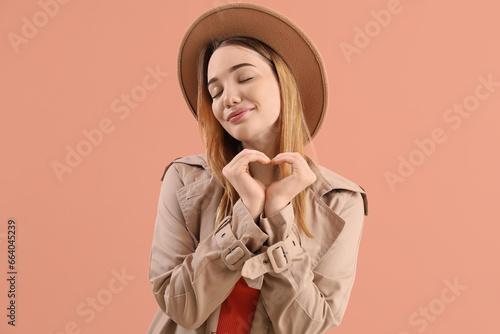 Young woman making heart wi...