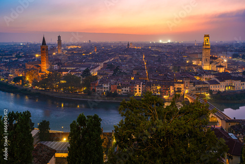 Verona, Veneto, Italy: Twilight skyline by river Adige with Saint Anastasia church,  Lamberti tower and hte cathedral of Verona photo