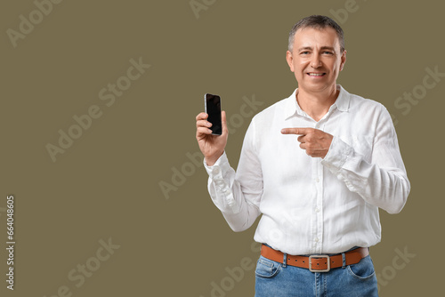Mature man pointing at mobi...