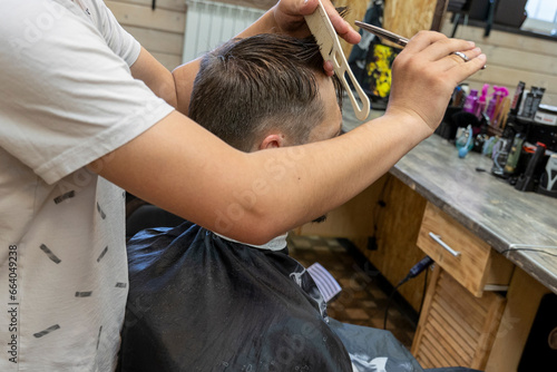  professional hairdresser cuts a man's hair. visit to the barber shop
