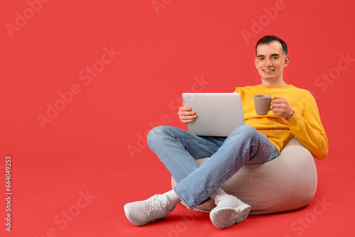 Young man with cup of coffe...