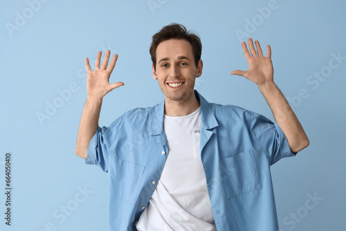 Young man showing hands on ...
