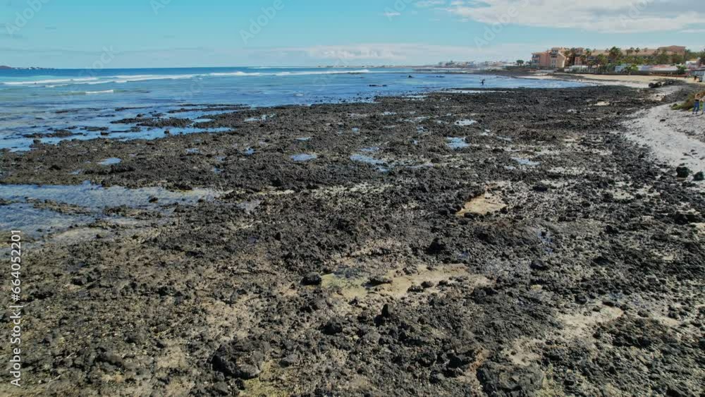Ocean waves break on the coast of black lava of volcanic origin in Canary Islands Ocean waves break on the coast of black lava of volcanic origin in Canary Islands