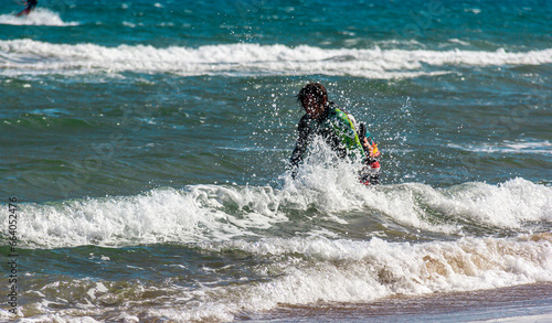 Sportsman practicing kite surf sport at the beach on a windy day