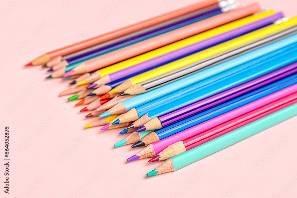 Heap of color pencils on pink background, closeup Heap of color pencils on pink background, closeup