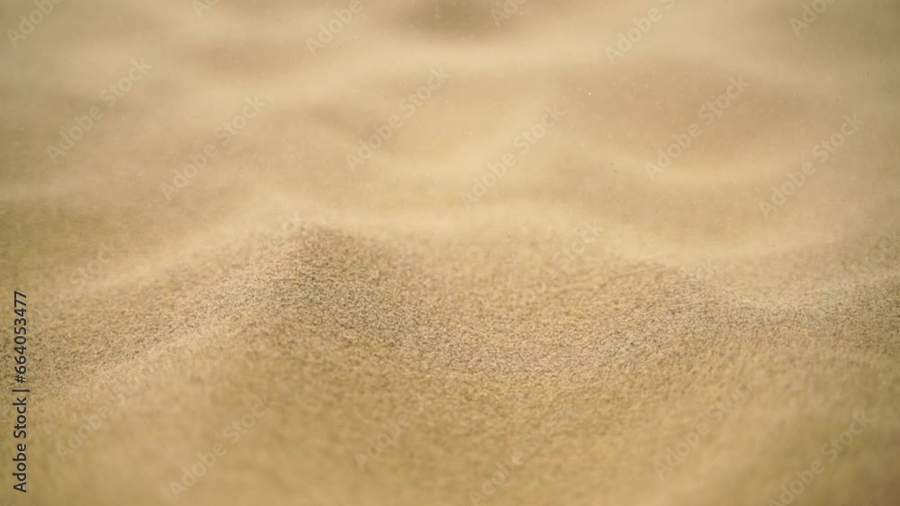 Sand blowing over dunes in wind, sandstorm in desert, close up Sand blowing over dunes in wind, sandstorm in desert, close up