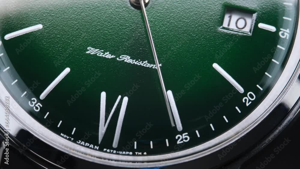 Stylish Luxury Man Wrist Watch With Moving Hand And Multiple Dials. Men's watch in metal with sapphire crystal. Closeup view of rotating watch, running second arrow. green dial. Stylish Luxury Man Wrist Watch With Moving Hand And Multiple Dials. Men's watch in metal with sapphire crystal. Closeup view of rotating watch, running second arrow. green dial.