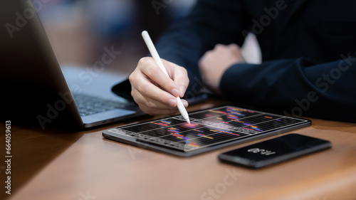 Businessman checks and manages his weekly schedule on a tablet.