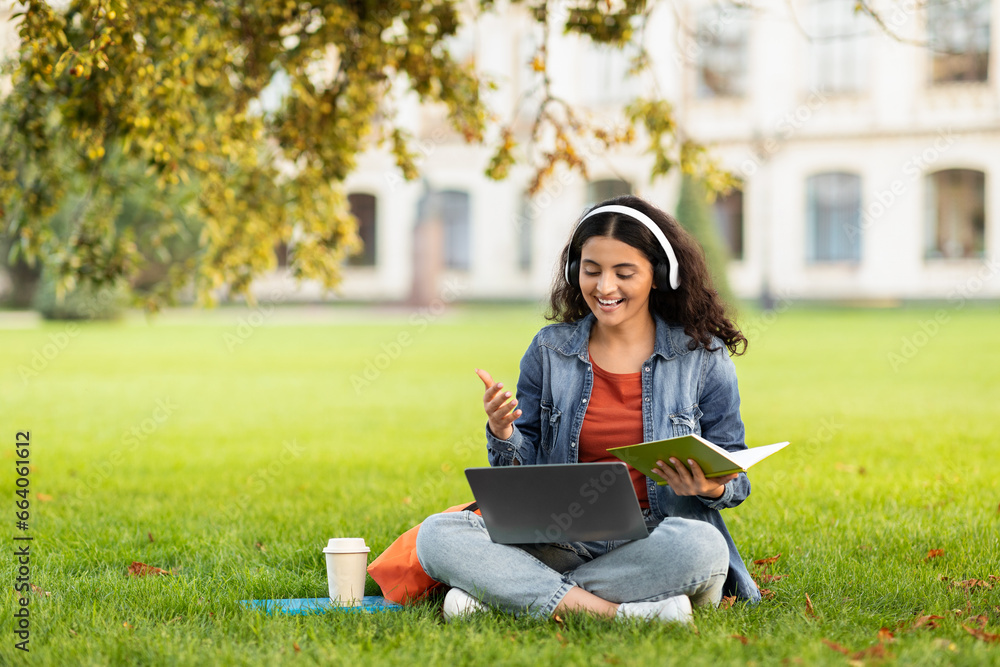 Young Eastern Woman Study Outdoors With Laptop And Headphone Young Eastern Woman Study Outdoors With Laptop And Headphone