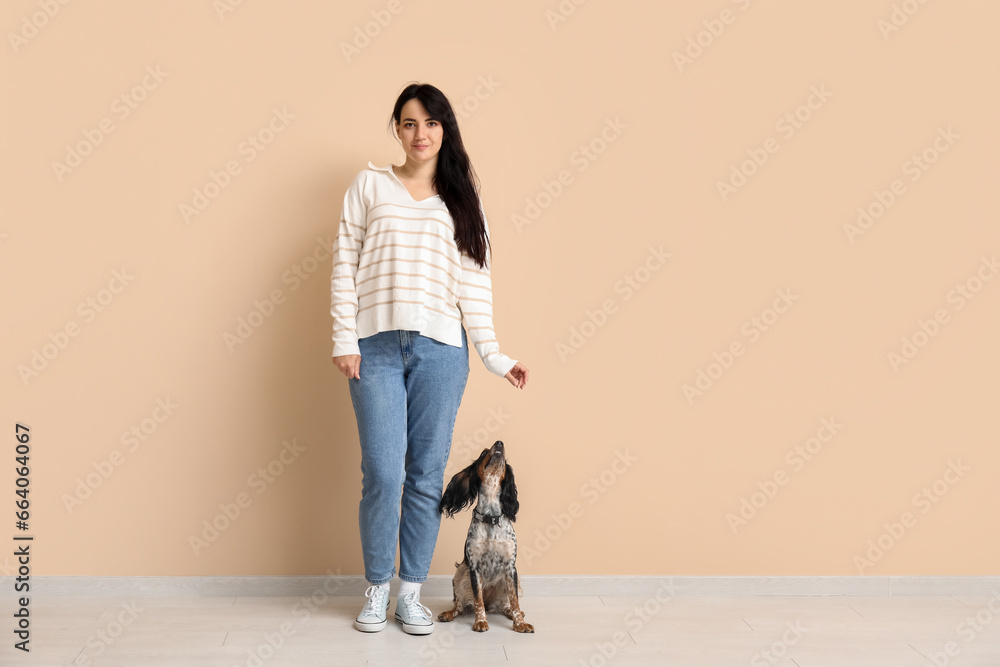 Dog handler with pet on beige background