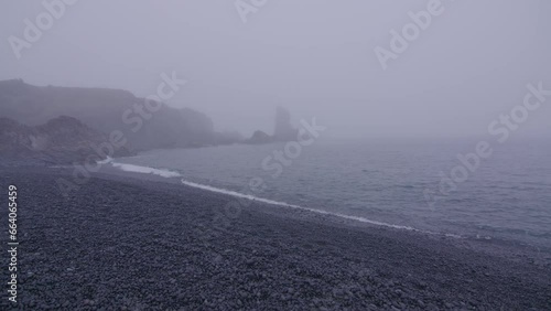 Rock formations in the fog Djupalonssandur black rock beach Iceland