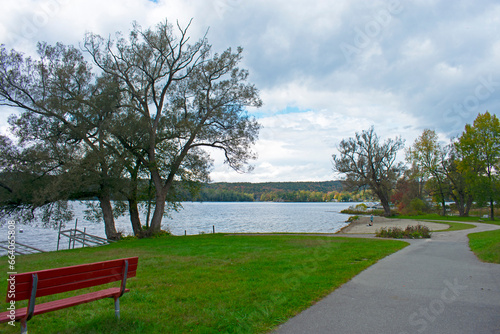 View of Lake Bomoseen, Vermont, and surrounding woods and hills including autumn foliage colors on a partly cloudy day photo