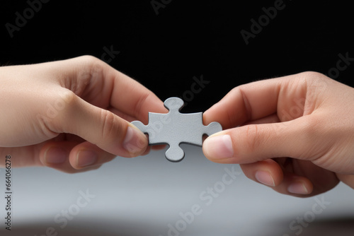 Two hands holding a puzzle. Concept of interaction, partnership