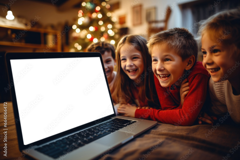 Joyful children with happy faces are sitting in front of an open laptop with space for text Joyful children with happy faces are sitting in front of an open laptop with space for text