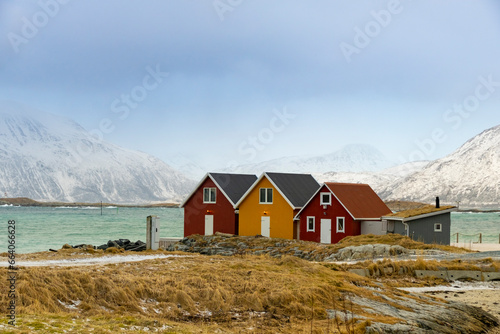 Winter Norway landscape with rorbu on the ocean beach and snow
