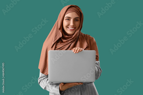 Young Muslim woman with lap...