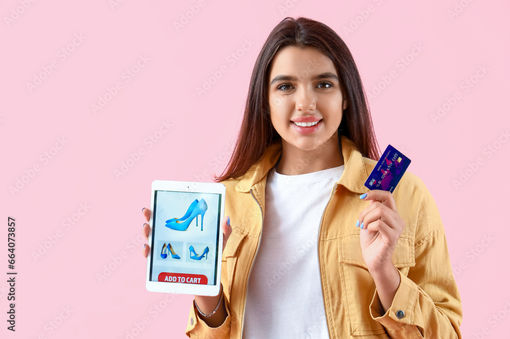 Young woman with tablet computer and credit card on pink background. Online shopping Young woman with tablet computer and credit card on pink background. Online shopping