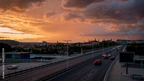 View of Prague from the Nuselský Bridge at sunset with the Prague skyline and the castle in the background. Storm clouds. © Premysl