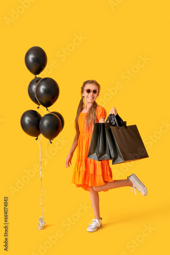 Little girl with balloons a...